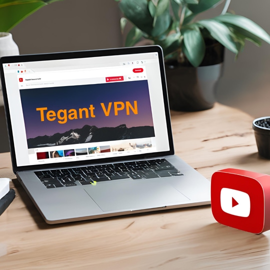 Ноутбук, отображающий 'Tegant VPN' на сайте YouTube, с растением и фигуркой логотипа YouTube на столе